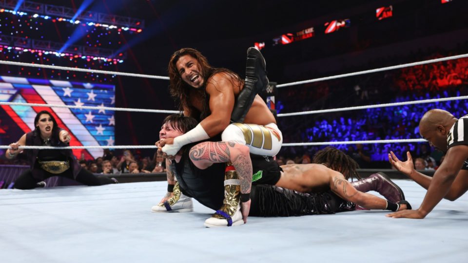 Mustafa Ali with submissions locked in on both Dominik Mysterio and Wes Lee